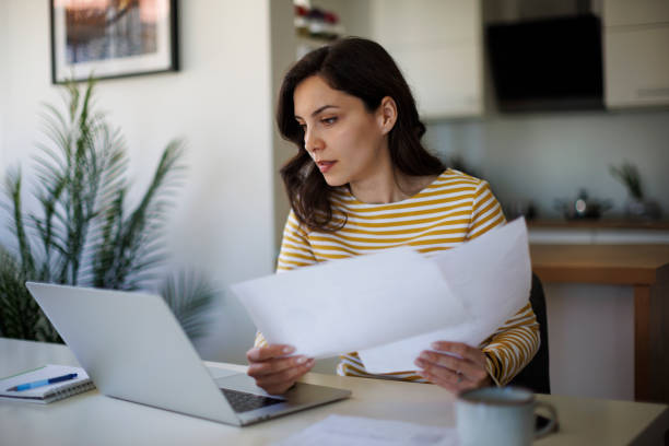 Person reviewing insurance claim documents on a laptop in Ontario.